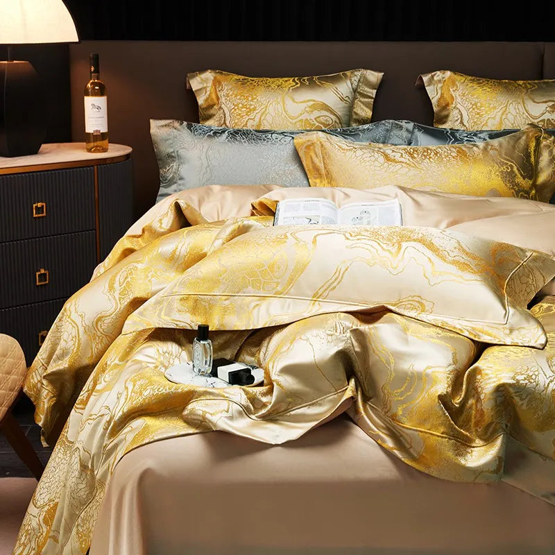 Detailed view of white and gold marble bedding with a fluid jacquard pattern and richly draped duvet corner – L&B