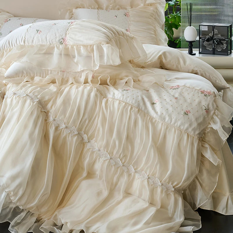Close view of ivory ruffled lace duvet cover with graceful floor-length draping, RUBYLACE IVORY – L&B
