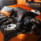 Detailed view of black and copper bedding with flowing satin jacquard folds and contrasting orange sheets – L&B