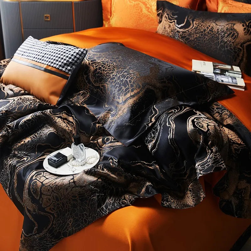 Detailed view of black and copper bedding with flowing satin jacquard folds and contrasting orange sheets – L&B