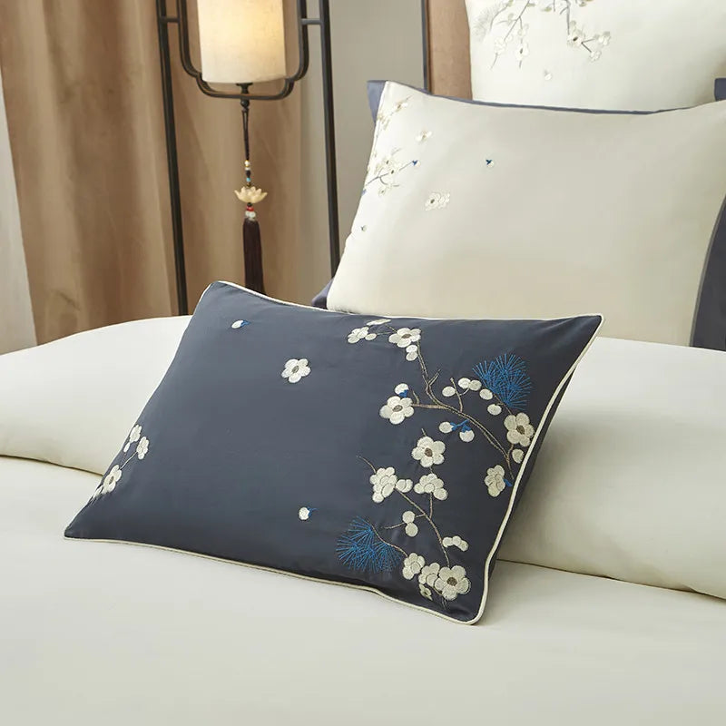 Ivory and gray decorative pillow with blue floral leaf embroidery on smooth Egyptian cotton bedding – L&B