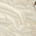 Ivory Egyptian cotton bedding fabric with a smooth finish, soft drape, and gentle natural folds – L&B