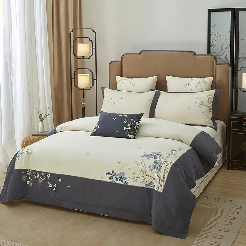 Gray floral duvet cover set with a soft ivory center, embroidered blue blossoms, and an elegantly draped border – L&B