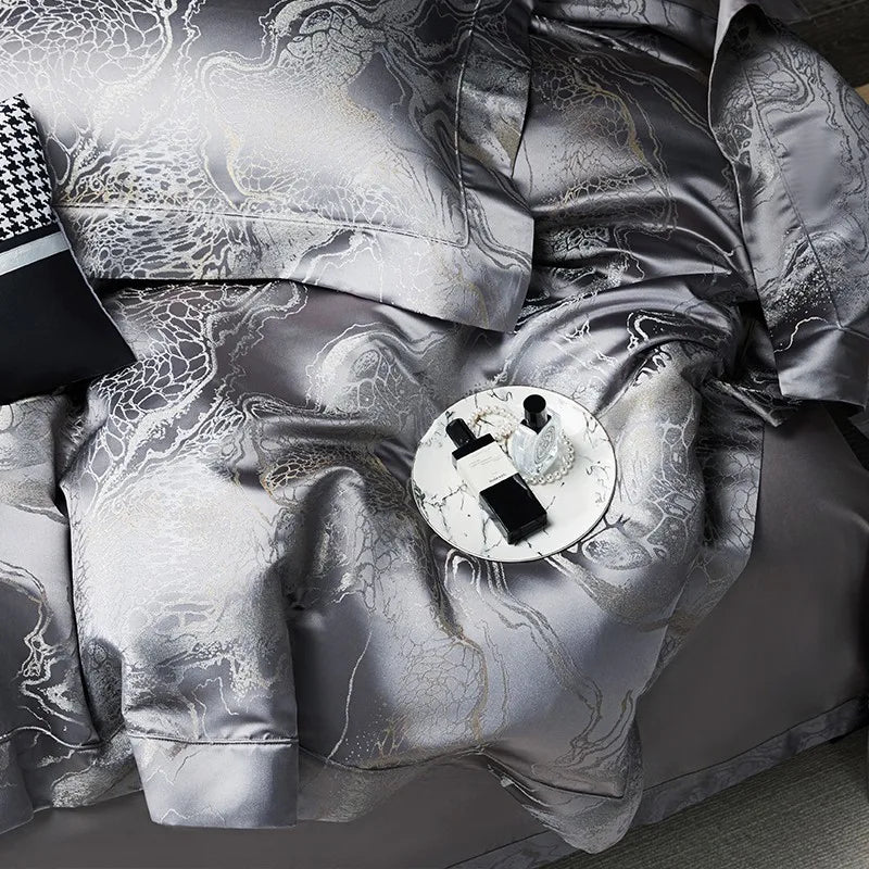Detailed view of dark gray jacquard bedding highlighting the dragon and cloud-inspired motif and metallic sheen – L&B