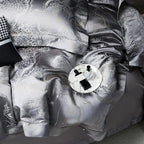 Detailed view of dark gray jacquard bedding highlighting the dragon and cloud-inspired motif and metallic sheen – L&B