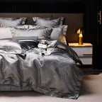 Gray jacquard bedding set with platinum detailing, layered pillows, and a sophisticated contemporary bedroom style – L&B