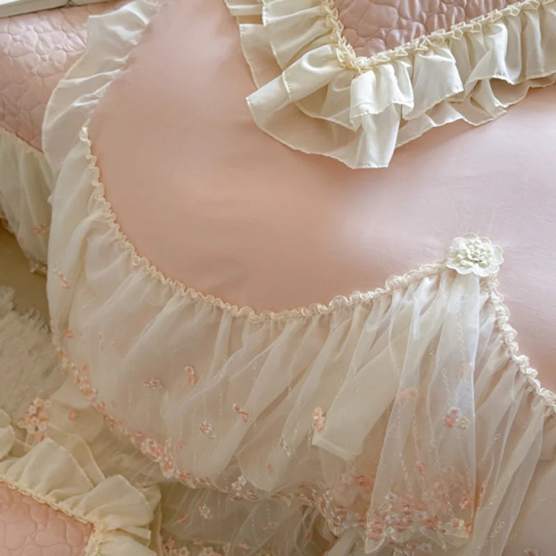 Heart-quilted blush pink bedding framed with ivory lace ruffles and romantic floral embroidery – L&B