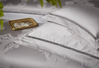 Layered silver gray pillow shams and damask duvet cover with tonal piping and a lustrous satin finish – L&B