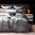 Gray jacquard bedding set with a shimmering silver duvet cover and layered pillows on an elegantly styled bed – L&B