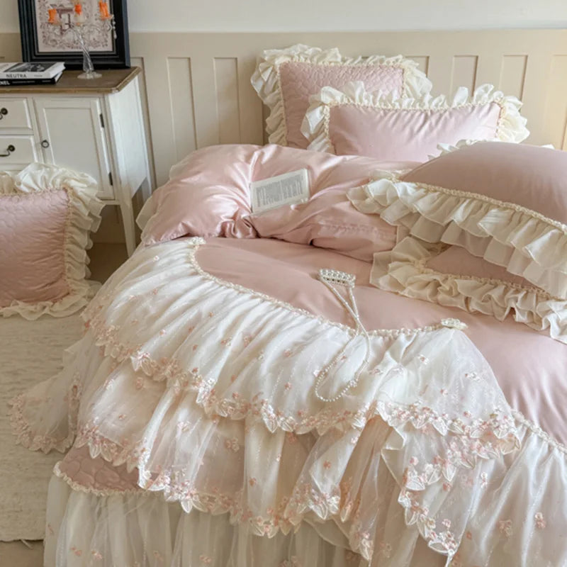 Blush pink princess bedding set styled with layered ruffle pillows and an embroidered cotton duvet cover – L&B