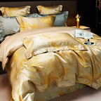 Gold jacquard duvet cover draped over a modern bed with coordinated pillow shams and a warm champagne sheen – L&B
