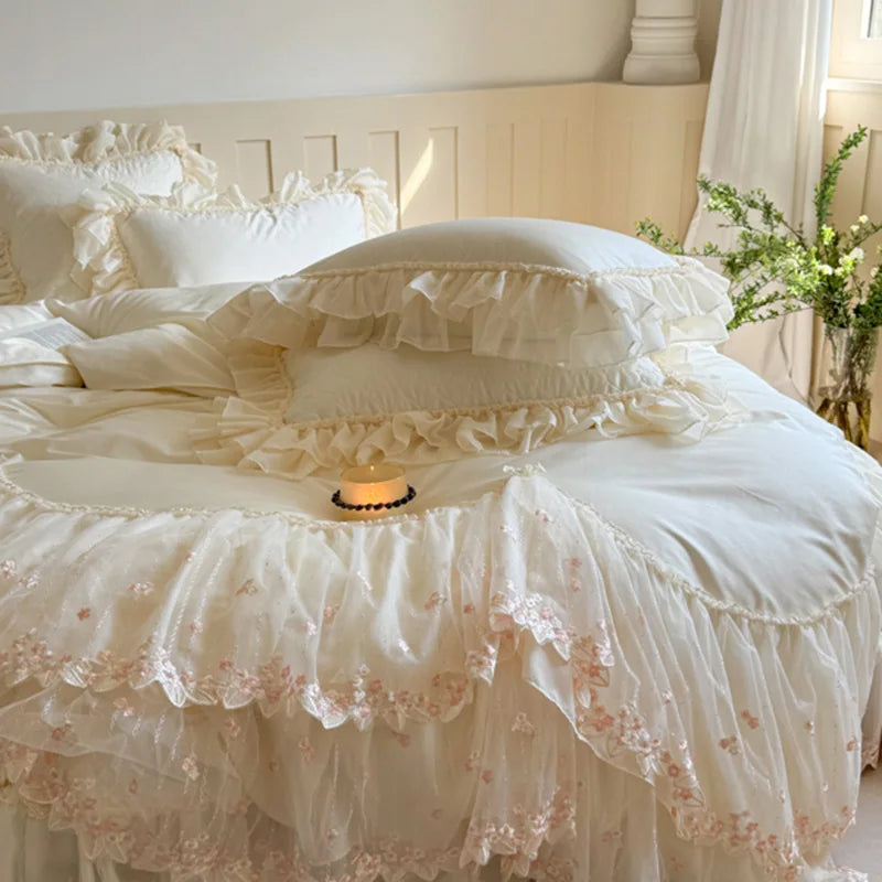 White princess bedding set styled with layered ruffle pillows and an ivory heart-quilted duvet cover – L&B