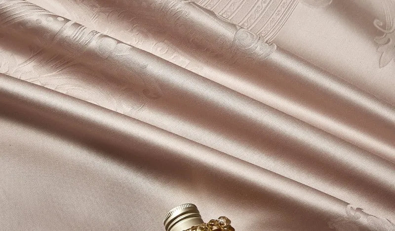 Close-up of smooth champagne beige 1200TC Egyptian cotton satin fabric with luminous folds and silky luster - L&B