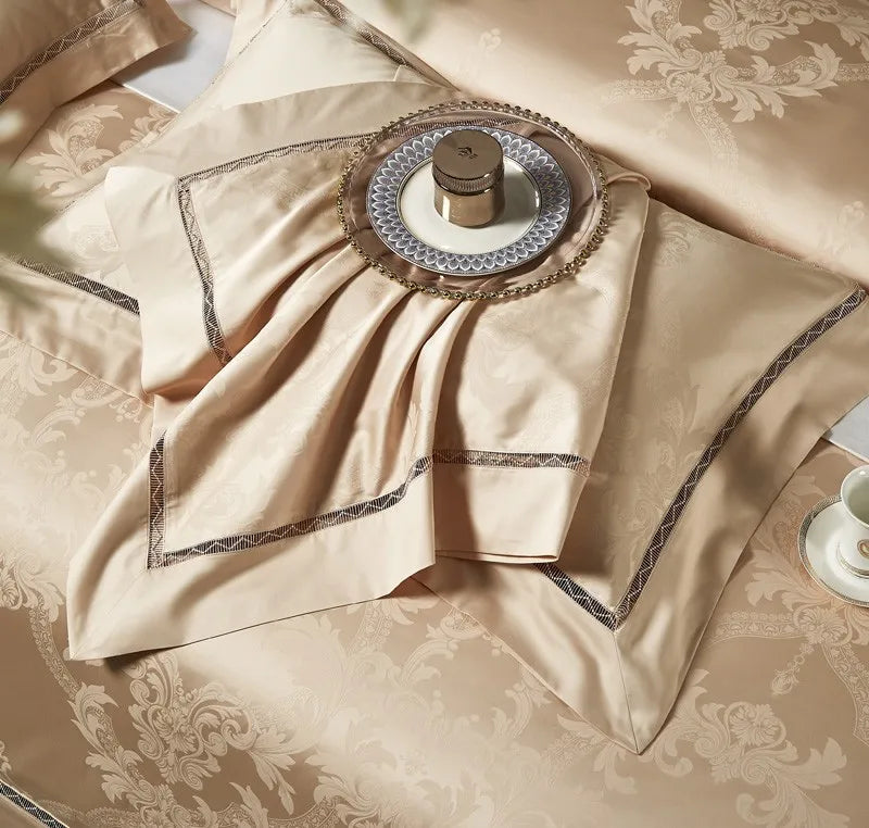 Luxury gold bedding draped in soft folds to highlight the damask weave and fluid satin sheen - L&B
