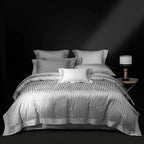 Silver gray striped duvet cover and quilted bedspread set styled in a tailored bedroom, LUSTRA SILVER – L&B