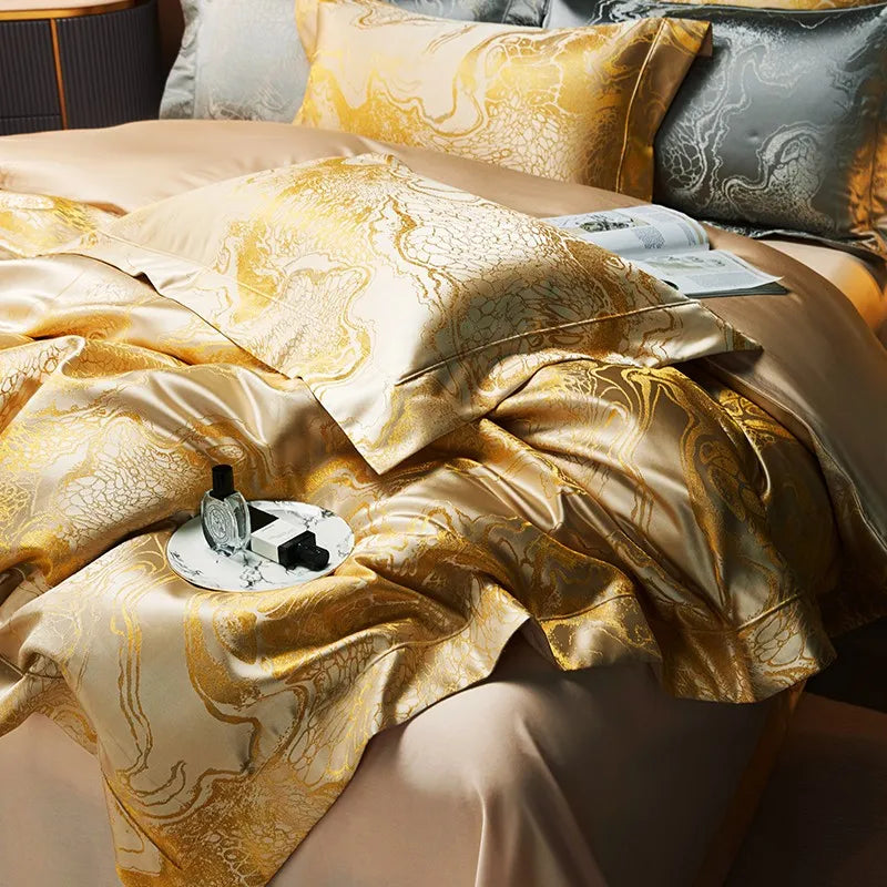 Close-up of gold satin jacquard bedding showing the fluid marble pattern, soft folds, and lustrous woven finish – L&B