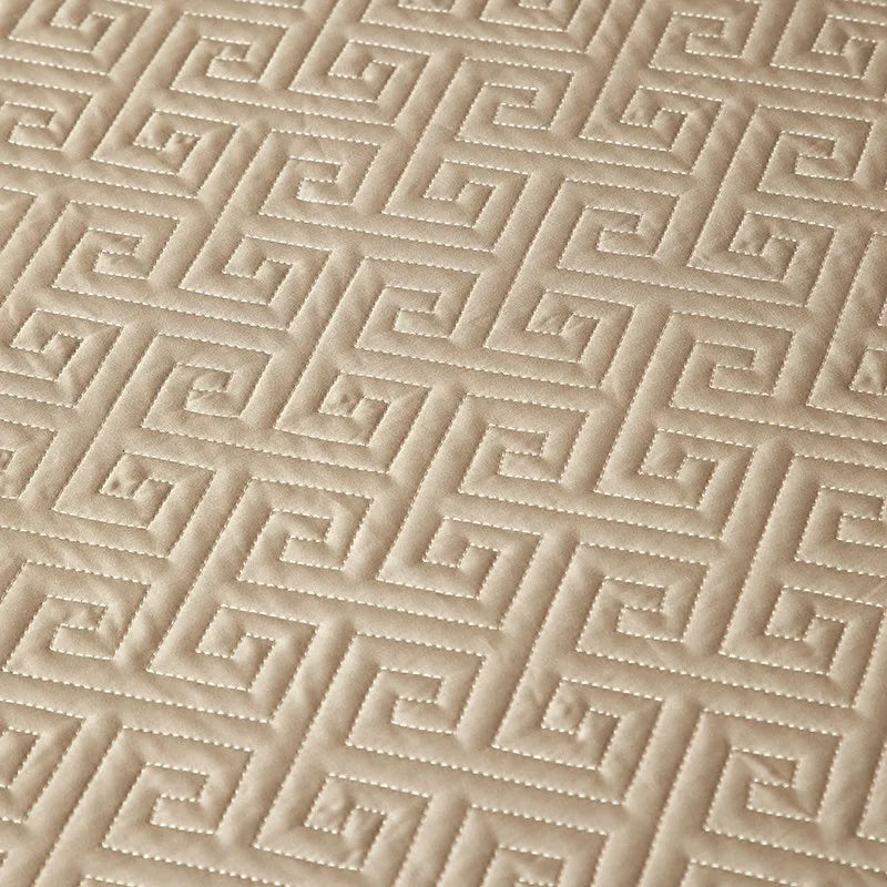 Close-up of champagne gold geometric quilted bedspread texture from LUSTRA GOLD – L&B