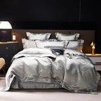 Silver gray jacquard duvet cover set with matching shams and layered pillows in a sophisticated modern bedroom – L&B