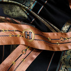 Close-up of copper-toned ornamental trim and braided edging on black satin bedding – ROYAL H. BLACK – L&B