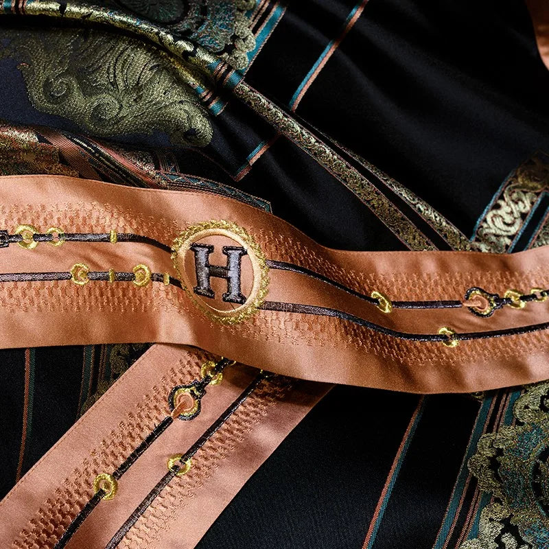 Close-up of copper-toned ornamental trim and braided edging on black satin bedding – ROYAL H. BLACK – L&B