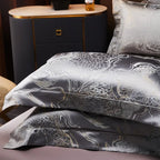 Dark gray jacquard pillow shams stacked to display their metallic woven pattern and sophisticated charcoal sheen – L&B