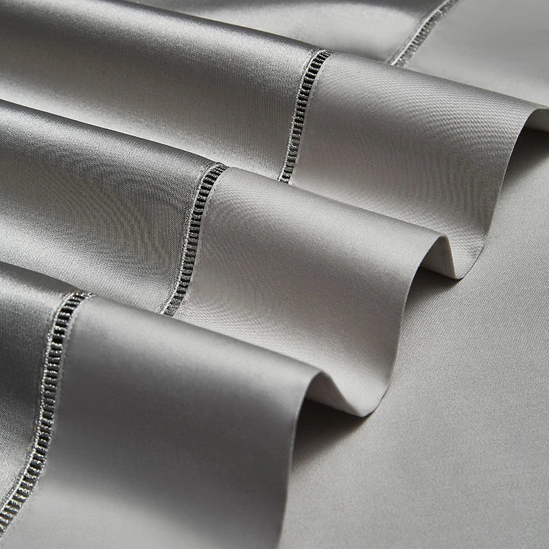 Decorative trimmed edges on folded silver gray Egyptian cotton satin bedding, SILVIORA – L&B