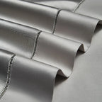 Decorative trimmed edges on folded silver gray Egyptian cotton satin bedding, SILVIORA – L&B