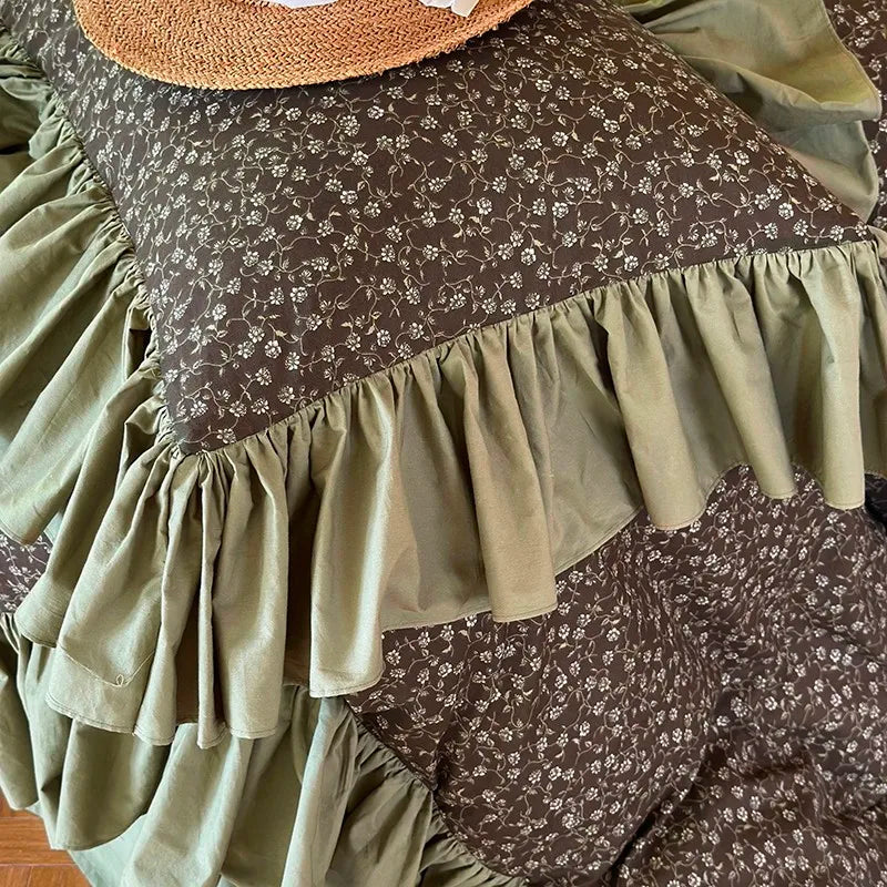 Close-up of wide olive green gathered ruffles framing the ditsy floral duvet cover, MOSSBELLE – L&B