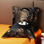 Black and gold jacquard pillow sham displayed with an ornate copper pattern and coordinating orange bedding – L&B