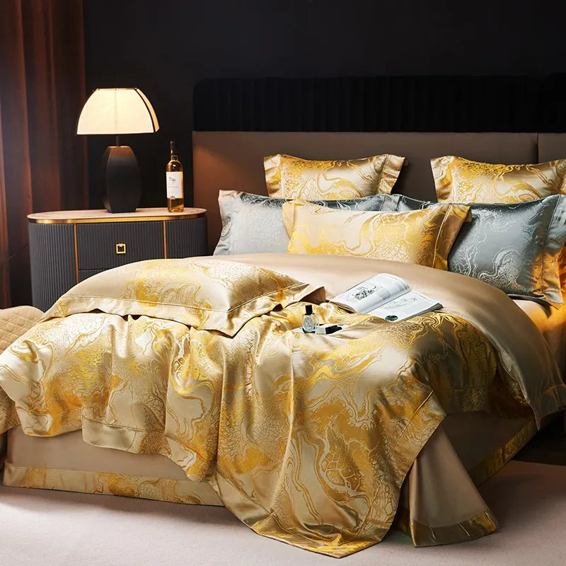 Champagne gold duvet cover set with luminous jacquard texture and blue-gray accent pillows on an elegant bed – L&B