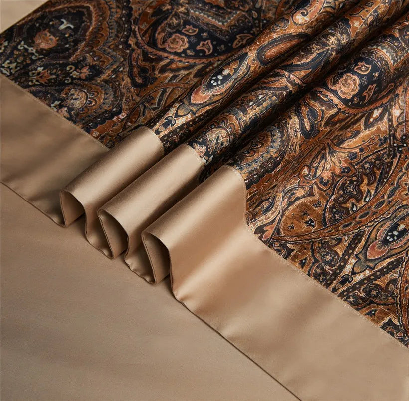 Close-up of brown paisley bedding with a tailored beige pleated border, ZUVRIC – L&B