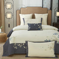 Embroidered Egyptian cotton bedding set with an ivory duvet cover, deep gray border, and delicate blue flowers – L&B