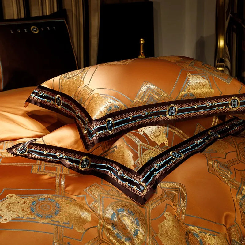 Orange baroque pillow shams with gold woven motifs, layered borders, and dimensional braided trim – ROYAL H. ORANGE – L&B