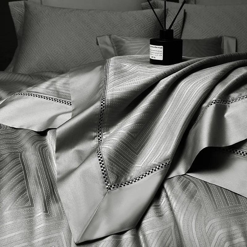 Pewter gray abstract geometric duvet cover layered with coordinating pillows and bedspread, LUSTRA PEWTER – L&B