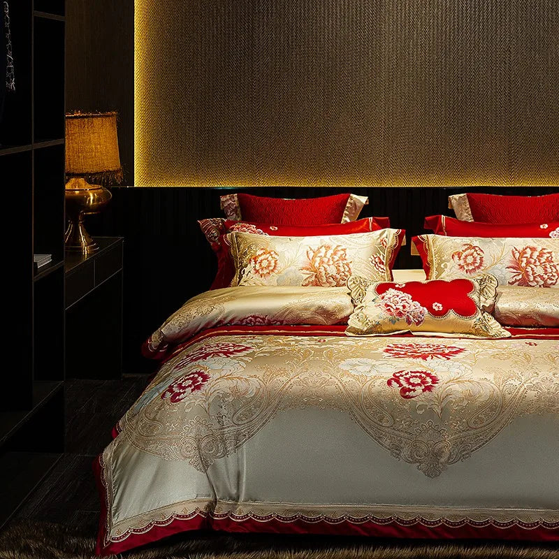 Romantic ivory floral bedding set with red embroidered accents, layered pillows, and an elegant satin sheen – L&B