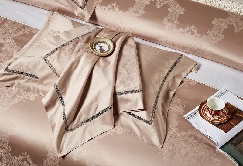 Champagne beige damask bedding draped in soft folds to highlight its woven pattern and fluid satin sheen - L&B