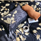 Close-up of black Egyptian cotton bedding with luminous gold botanical leaf print – L&B