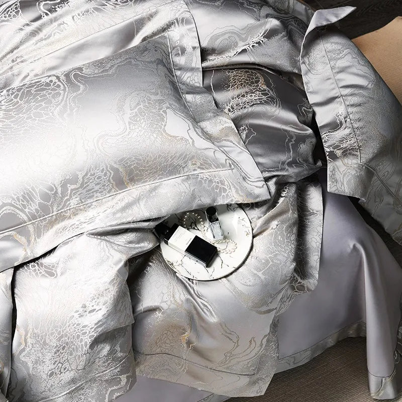 Detailed view of silver gray jacquard bedding highlighting the dragon and cloud motif and reflective platinum sheen – L&B