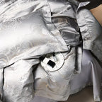 Detailed view of silver gray jacquard bedding highlighting the dragon and cloud motif and reflective platinum sheen – L&B