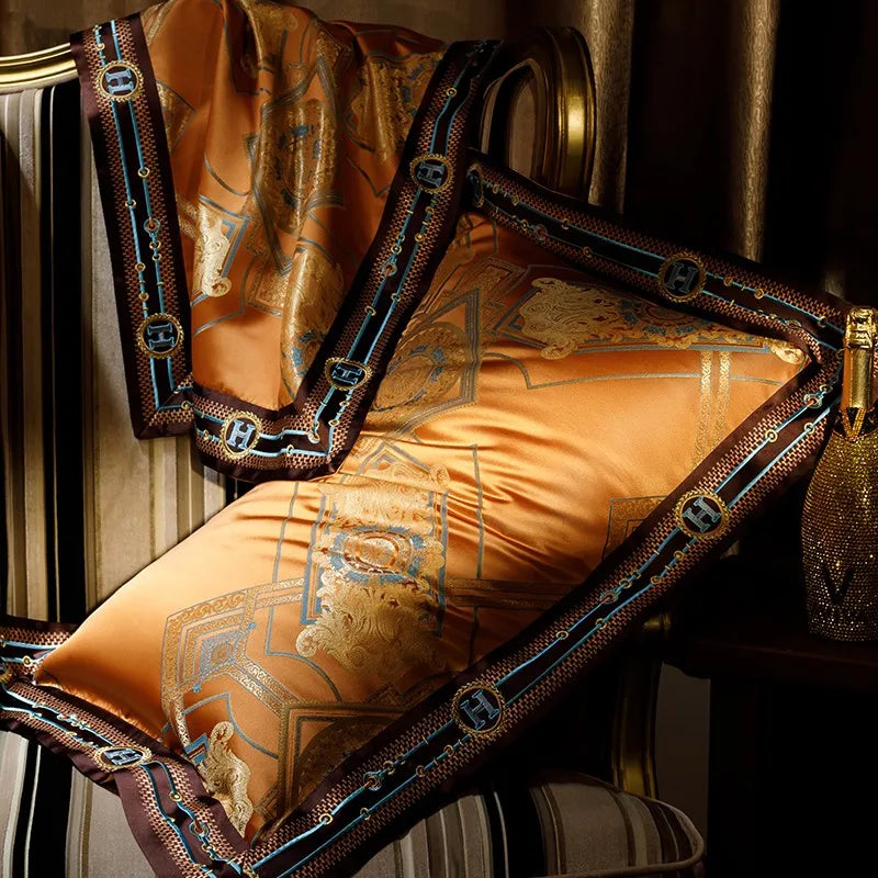 Close-up of burnt orange Egyptian cotton satin bedding with gold jacquard and structured dark piping – ROYAL H. ORANGE – L&B