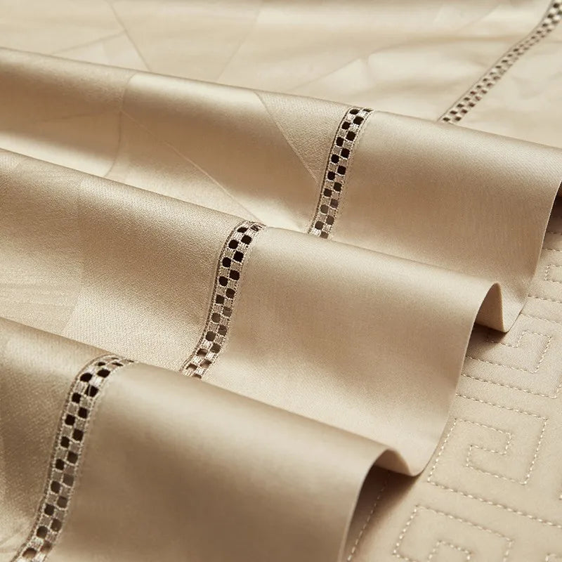 Close-up of champagne gold long-staple cotton bedding with delicate openwork edge trim, LUSTRA GOLD – L&B