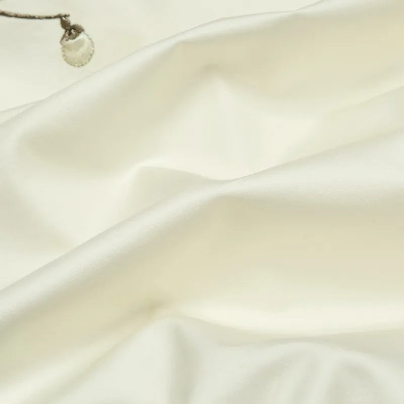 Ivory Egyptian cotton bedding fabric with a smooth finish, soft drape, and gentle natural folds – L&B