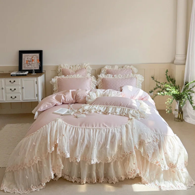 Pink princess cottagecore bedroom styled with floral embroidered bedding, lace ruffles, and layered pillows – L&B