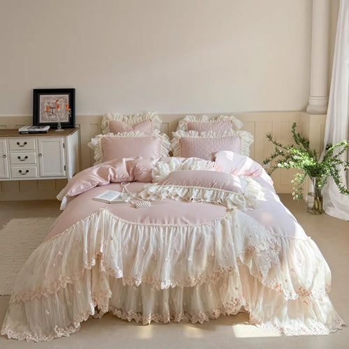 Pink princess cottagecore bedroom styled with floral embroidered bedding, lace ruffles, and layered pillows – L&B