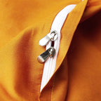 Close-up of the concealed zipper closure on the smooth burnt orange reverse side of the black duvet cover – L&B