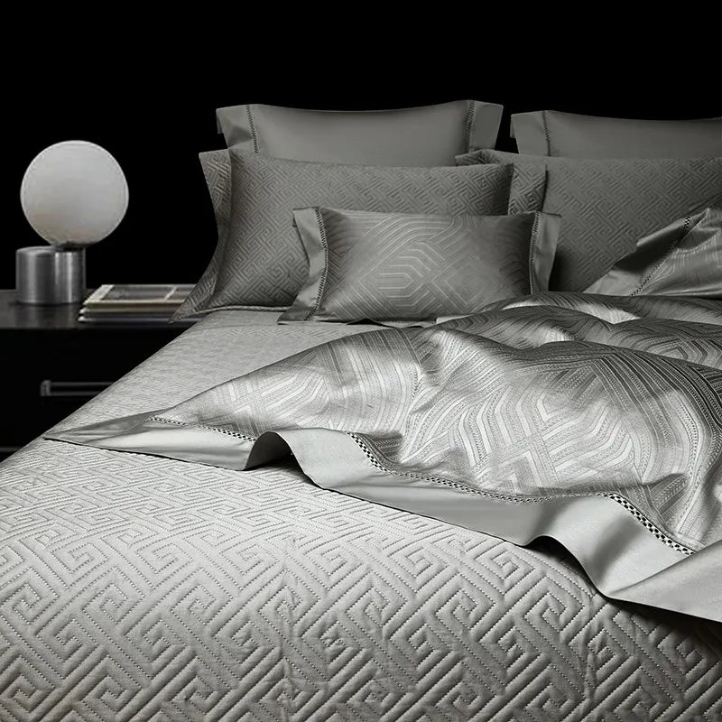 Pewter gray geometric duvet cover layered with coordinating pillows and bedspread, LUSTRA PEWTER – L&B