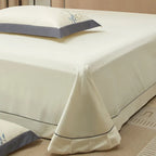 Ivory Egyptian cotton flat sheet with a smooth drape, tailored hem, and softly ruffled edge – L&B