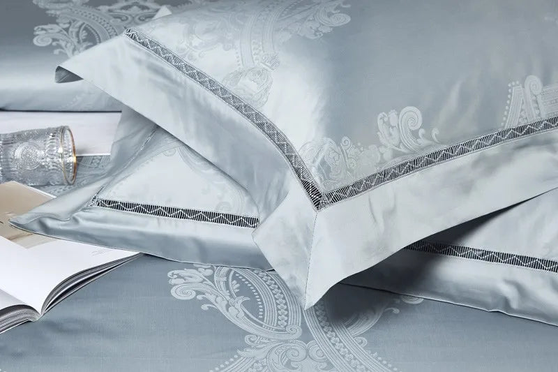 Coordinating sky blue pillow shams with damask detailing, braided trim, and a lustrous satin finish – L&B