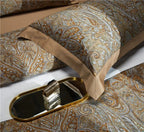 Close-up of layered gold and pale blue baroque pillow shams, ZLIKAN – L&B
