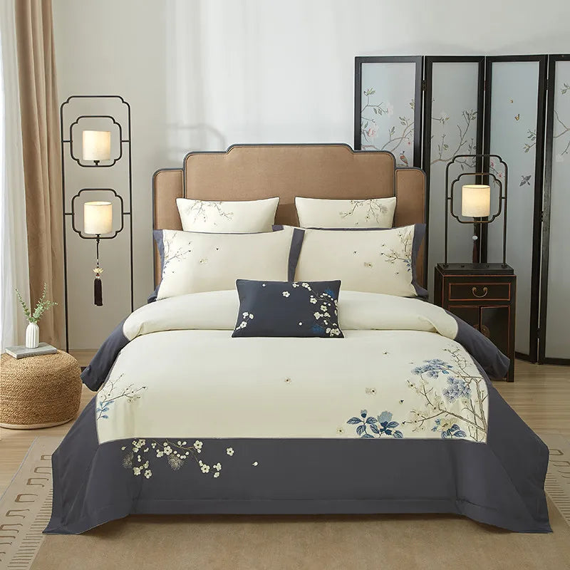Ivory and gray floral duvet cover set with blue botanical embroidery, layered shams, and a tailored gray border – L&B